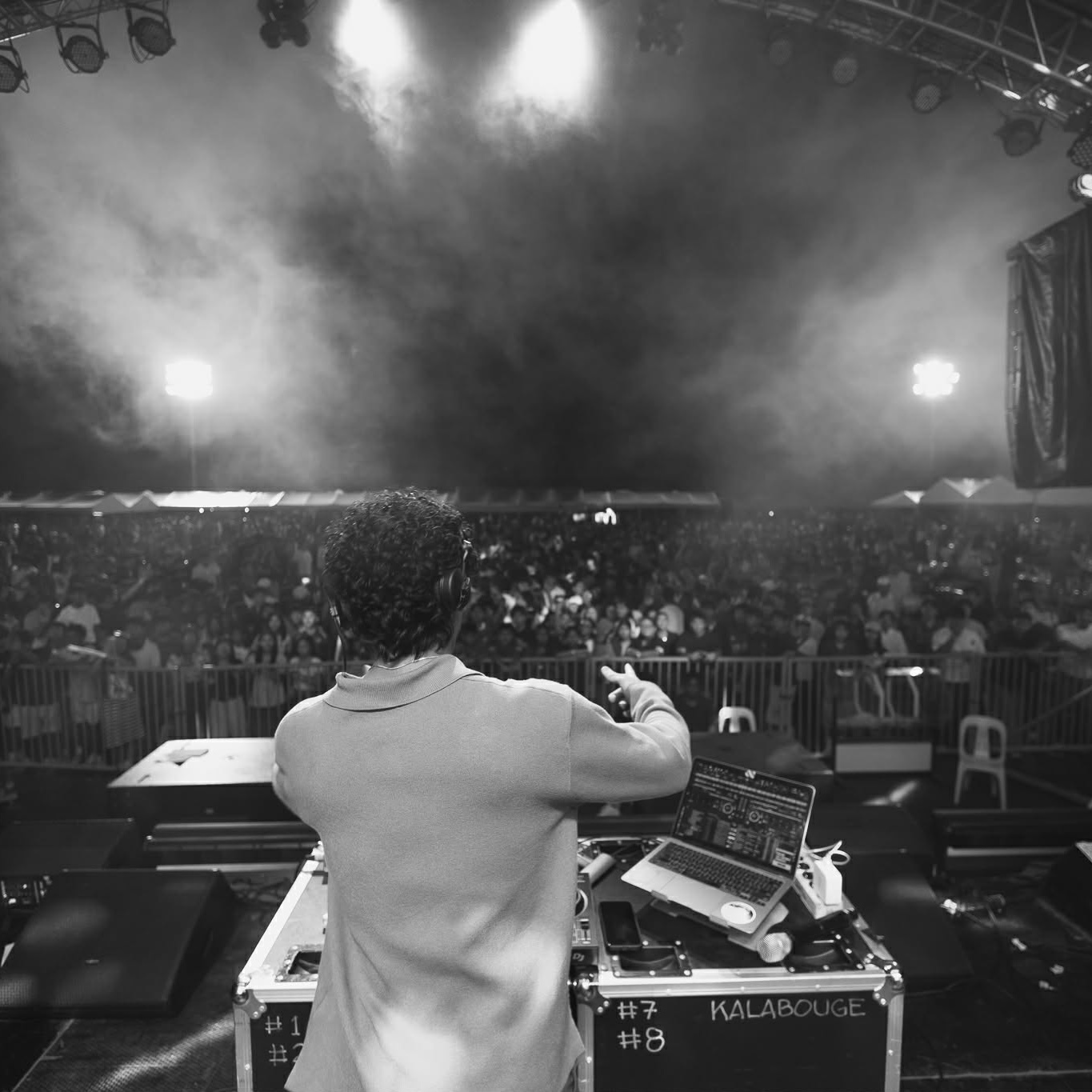 Bomski DJing on stage in front of a crowd